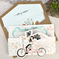 39629-esküvői meghívó-biciklis, comic, krém, rajz, vicces, virág-Erdélyi Esküvői Meghívók